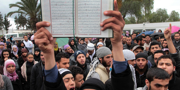 In this Wednesday March 7, 2012 photo an ultraconservative Muslim demonstrates with a Quran at the Manouba university in Tunis after scuffles erupted between Salafists students and members of a leftist students union. In the birthplace of the Arab Spring, the transition from dictatorship to democracy has been mostly smoother than in neighboring countries, with no power hungry military or armed militias to stifle the process. But as a moderate Islamist party rules with the help of secular forces, an unexpected threat has emerged: the increasing boldness of ultraconservative Muslims known loosely as Salafis, who want to turn this North African country of 10 million into a strict Islamic state. (AP Photo/Amine Landoulsi, File)