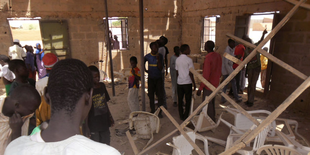 People gather inside the Redeemed Christian Church of God, after a bomb blast in Potiskum, Nigeria, Sunday, July 5, 2015. A woman suicide bomber blew up in the midst of a crowded evangelical Christian church service in northeast Nigeria on Sunday and killed at least five people, witnesses said.(AP Photo/Adamu Adamu Damaturu)