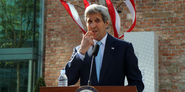 U.S. Secretary of State John Kerry informs the media in front of Palais Coburg where closed-door nuclear talks with Iran take place in Vienna, Austria, Sunday, July 5, 2015. (AP Photo/Ronald Zak)
