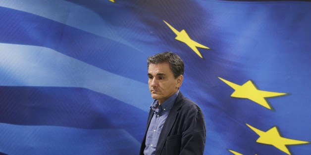 New Greek Finance Minister Euclid Tsakalotos arrives for a hand over ceremony in Athens, Monday, July 6, 2015. Following Sunday's referendum the Greece and its membership in Europe's joint currency faced an uncertain future Monday, with the country under pressure to restart bailout talks with creditors as soon as possible after Greeks resoundingly rejected the notion of more austerity in exchange for aid. (AP Photo/Petr David Josek)