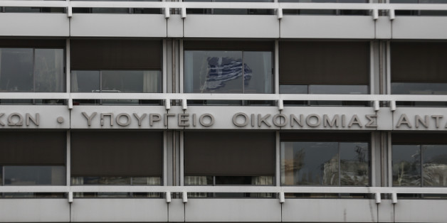 A Greek flag is reflected on a glass window of the Finance Ministry in Athens, Monday, Feb. 23, 2015. Greece will present a list of proposed reforms to debt inspectors on Monday to get final approval for an extension to its rescue loans. But already the government was facing dissent within its ruling party over claims it is backtracking on its promise to ease budget cuts for the recession-battered Greeks. (AP Photo/Yorgos Karahalis)