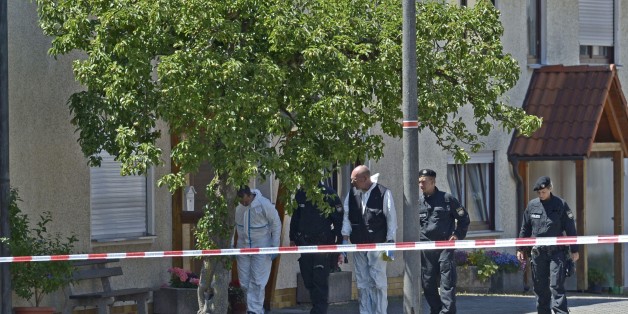 Police are seen investigating a crime scene in Tiefenthal-Leutershausen near Ansbach, southern Germany, after a gunman in a car killed a woman and a cyclist in drive-by shootings on July 10, 2015. The shooter, travelling in a silver Mercedes convertible, also fired at or threatened a farmer and another motorist, before being arrested at a petrol station near the shootings. AFP PHOTO / THOMAS KIENZLE (Photo credit should read THOMAS KIENZLE/AFP/Getty Images)