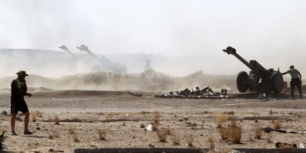 Iraqi Shiite fighters from the Popular Mobilisation units supporting the Iraqi government forces launch rockets towards Islamic State (IS) group positions during clashes on the northern outskirts of the city of Fallujah, west of the capital Baghdad, on July 7, 2015. AFP PHOTO/ AHMAD AL-RUBAYE (Photo credit should read AHMAD AL-RUBAYE/AFP/Getty Images)