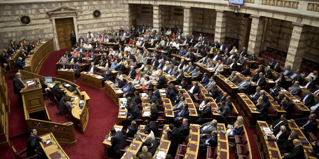 Greek Lawmakers attend an emergency Parliament session for the governmentâs proposed referendum in Athens on Saturday, June 27, 2015. Germany's vice chancellor says that a Greek referendum on the bailout talks could in principle make sense, but notes that it should be clear to voters what they will be deciding on.(AP Photo/Petros Giannakouris)