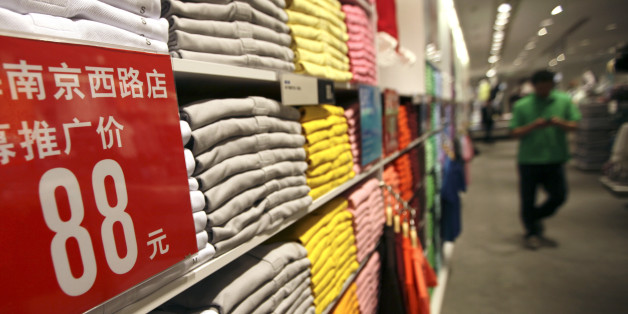 A guest walks interior of the largest global flagship store of Uniqlo Thursday, May 13, 2010 in Shanghai, China. The UNIQLO Shanghai Global Flagship Store will open on May 15 officially. (AP Photo/Eugene Hoshiko)
