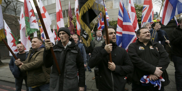 Members of Britain First, a far-right nationalist political party, protest across the street from London Central Mosque during prayers in Regent's Park, London, Friday, April 3, 2015. (AP Photo/Tim Ireland)