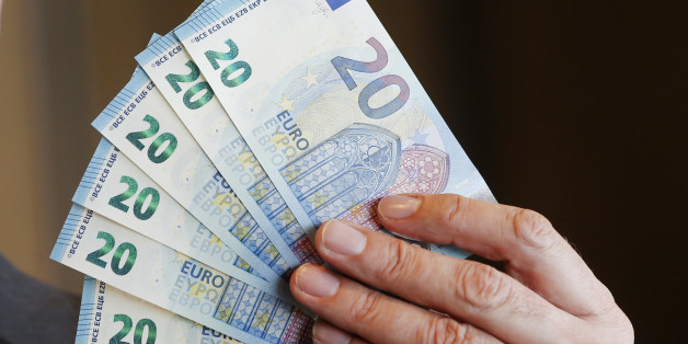 New 20 Euro bank notes are displayed in Frankfurt, Germany, Wednesday, March 4, 2015. The banknote with new security features and different design will be put out in November. (AP Photo/Michael Probst)