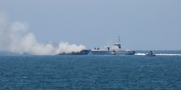 A picture shows an Egyptian naval vessel approaching another army boat on fire on the maritime border between Egypt and the Palestinian Gaza Strip, off the coast of Rafah in southern Gaza, on July 16, 2015. The Egyptian army said the vessel was set ablaze during a clash with militants in the restive Sinai Peninsula. AFP PHOTO / SAID KHATIB (Photo credit should read SAID KHATIB/AFP/Getty Images)