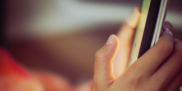Close up of mixed race girl using cell phone