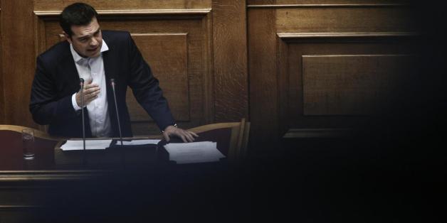 Greece's Prime Minister Alexis Tsipras speaks with a minister of his government during a parliament meeting in Athens, Thursday, July 16, 2015. Greece's Parliament has approved an austerity bill demanded by bailout creditors, despite a significant level of dissent from the governing leftist Syriza party. The bill to impose sweeping tax hikes and spending cuts was approved with the support of three pro-European opposition parties. (AP Photo/Thanassis Stavrakis)