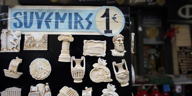 A one euro price sign sits on a display of souvenir fridge magnets for sale to tourists outside a euro store in Athens, Greece, on Thursday, Jan. 8, 2015. Greek Prime Minister Antonis Samaras's effort to overhaul opposition Syriza party's lead before elections in less than three weeks is running out of steam, polls show. Photographer: Kostas Tsironis/Bloomberg via Getty Images
