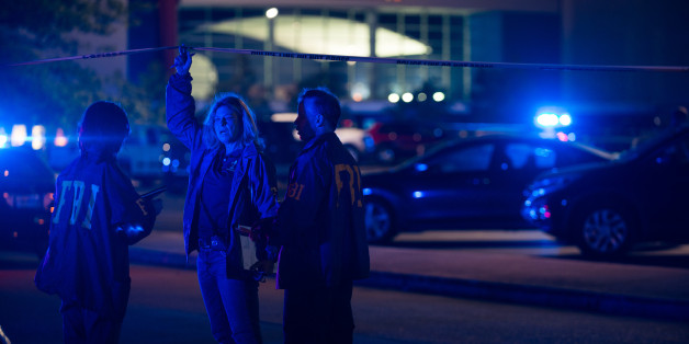 Federal investigators respond to the scene of a shooting at the Grand Theatre on Thursday, July 23, 2015, in Lafayette, La. (AP Photo/Denny Culbert)