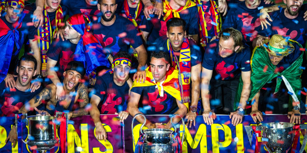 BARCELONA, SPAIN - JUNE 07: FC Barcelona players celebrate with La Liga, Copa del Rey and Champions League trophies during their victory parade after winning the UEFA Champions League Final at the Camp Nou Stadium on June 7, 2015 in Barcelona, Spain. (Photo by David Ramos/Getty Images)
