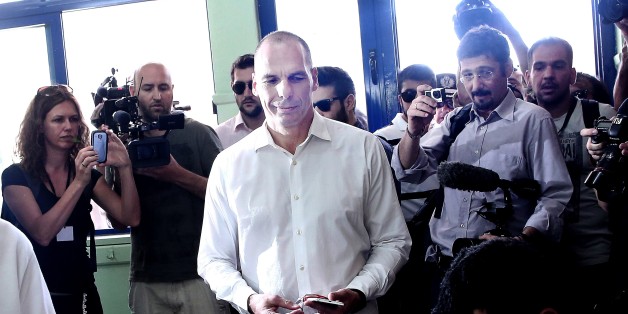 Greek Finance Minister Yanis Varoufakis (C) prepares to cast his ballot during the Greek referendum on its bailout terms in Athens on July 5, 2015. Greece voted in a tightly fought referendum on July 5 that Prime Minister Alexis Tsipras said will determine its 'destiny' in the eurozone, as the EU country teetered on the brink of financial collapse. AFP PHOTO / ANGELOS TZORTZINIS (Photo credit should read ANGELOS TZORTZINIS/AFP/Getty Images)