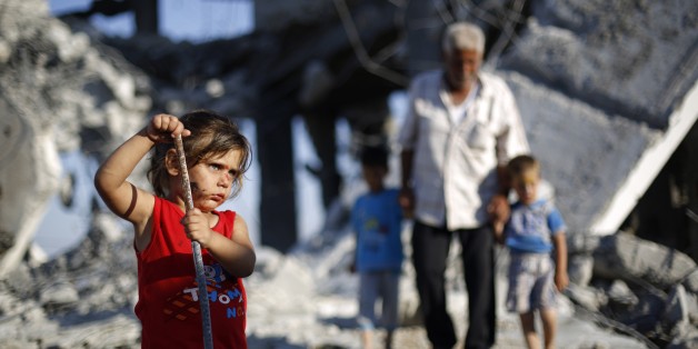 A Palestinian girl plays in the rubble of buildings, reportedly destroyed during the 50-day war between Israel and Hamas militants in the summer of 2014, in Gaza City on July 21, 2015. AFP PHOTO / MOHAMMED ABED (Photo credit should read MOHAMMED ABED/AFP/Getty Images)