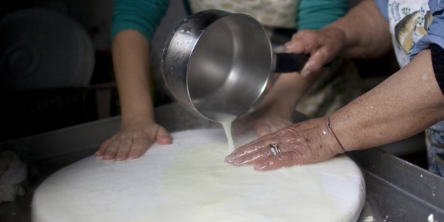 Women prepare traditional halloumi cheese at a house in the Cypriot village of Astromeritis, located some 30 km west of the capital Nicosia on the foothills of the Troodos mountains, on February 25, 2015. Halloumi, which has been made in Cyprus for centuries, traditionally from a mixture of sheep and goat's milk, is currently the Mediterranean island's second-largest export. AFP PHOTO / FLORIAN CHOBLET (Photo credit should read FLORIAN CHOBLET/AFP/Getty Images)