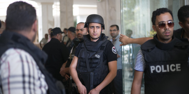 Tunisian police officers stay in the lobby of an hotel where a terrorist attack took place in the coastal town of Sousse, Tunisia, Friday June 26, 2015. A young man unfurled an umbrella and pulled out a Kalashnikov, opening fire on European sunbathers in an attack that killed at least 28 people at a Tunisian beach resort â one of three deadly attacks from Europe to the Middle East on Friday that followed a call to violence by Islamic State extremists. (AP Photo/Leila Khemissi)