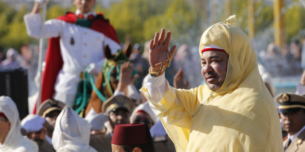 Morocco's King Mohammed VI waves to the crowd as he stands in a limousine during a ceremony of allegiance, at the king's palace in Rabat, Morocco, Thursday July 31, 2014, as part of the ceremonies marking the 15th anniversary of his accession to the throne. (AP Photo/Abdeljalil Bounhar)