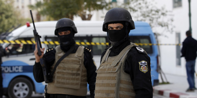 Police officers guard the entrance of the National Bardo Museum a day after gunmen opened fire killing scores of people in Tunis, Thursday, March 19, 2015. One of the gunmen who killed tourists and others at a prominent Tunisian museum was known to intelligence services, but no formal links to a particular extremist group have been established, the prime minister said Thursday. (AP Photo/Christophe Ena)