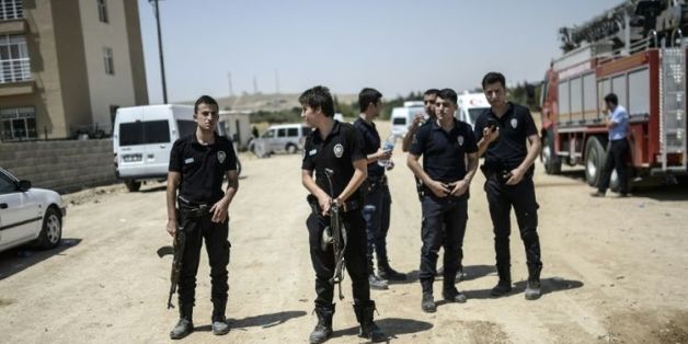 Des policiers turcs surveillent le 22 juillet 2015 un immeuble de la ville de Ceylanpinar, prés de la Syrie, après la mort de deux collègues abattus par le PKK