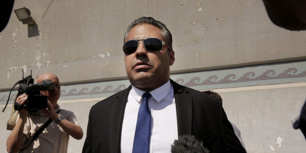 Canadian Al-Jazeera English journalist Mohammed Fahmy, speaks to the media in front of Tora prison, in Cairo, Egypt, Thursday, July 30, 2015. Egyptian judicial officials say a Cairo court has postponed the verdict in the retrial of three Al-Jazeera English reporters until Aug. 2. (AP Photo/Nariman El-Mofty)