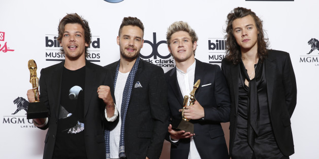 Louis Tomlinson, from left, Liam Payne, Niall Horan, and Harry Styles of the musical group One Direction pose in the press room with the awards for top duo/group and top touring artist at the Billboard Music Awards at the MGM Grand Garden Arena on Sunday, May 17, 2015, in Las Vegas. (Photo by Eric Jamison/Invision/AP)