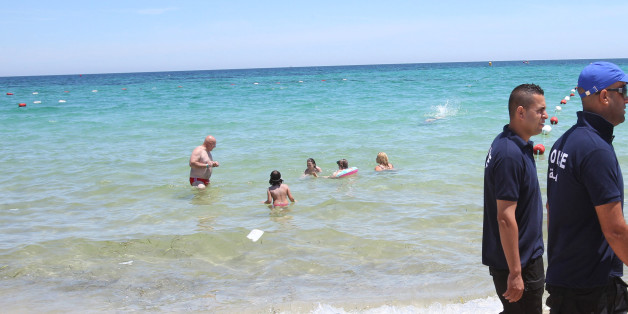 Police officers patrol on the beach near the Imperial Marhaba Hotel in Sousse,, Tunisa, four days after Friday's terrorist attack, Tuesday, June 30, 2015. One of Tunisia's top security officials says the gunman who killed 38 tourists, mostly Britons, in a beach attack was trained in neighboring Libya at the same time as the attackers who targeted the Bardo museum in March. (AP Photo/Abdeljalil Bounhar)