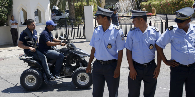 Tunisian police officers guard the Imperial Marhaba hotel during visit of top security officials of Britain, France, Germany and Belgium in Sousse, Tunisia, Monday, June 29, 2015. British Home Secretary Theresa May, French Interior Minister Bernard Cazeneuve, German Interior Minister Thomas de Maiziere and Belgian Interior Minister Jan Jambon joined their Tunisian counterpart on the beach in front of the Imperial Marhaba hotel in the Mediterranean resort of Sousse for the tribute Monday. (AP Pho