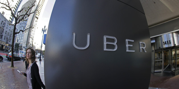 In this Tuesday, Dec. 16, 2014 photo, a woman leaves the headquarters of Uber in San Francisco. Venture capitalists poured a whopping $48.3 billion into U.S. startup companies last year, investing at levels that haven't been seen since before the dot-com bubble burst in 2001, according to a new report issued Friday, Jan. 16, 2015. The two biggest deals in 2014 were separate rounds of investment in Uber Technologies, the high-flying and controversial ride-hailing service, now valued at $41 billio