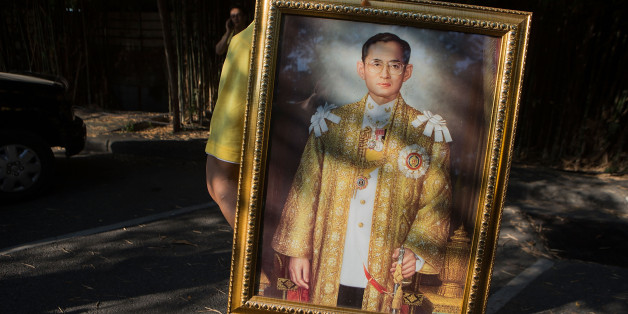 CHIANG MAI, THAILAND - DECEMBER 03: A Thai man carries a portrait of the King during a parade and ceremony in honor of the King's birthday on December 3, 2014 in Chiang Mai, Thailand. December 5th marks the 87th birthday of King Bhumibol Adulyadej of Thailand, the world's longest reigning monarch. (Photo by Taylor Weidman/Getty Images)