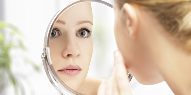 face of young beautiful healthy woman and reflection in the mirror