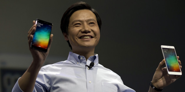Lei Jun, chairman of Chinese smartphone maker Xiaomi, holds up the latest models of the Xiaomi Note at a press event in Beijing, Thursday, Jan. 15, 2015. The Chinese manufacturer on Thursday unveiled a new model that Lei said has processor size and performance comparable to Appleâs iPhone 6 but is thinner and lighter. (AP Photo/Ng Han Guan)
