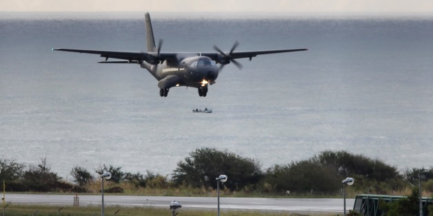 A CASA 235 plane from the 181st Air Detachment of the French Air Force taking part in the search for wreckage from the missing MH370 plane lands in Saint-Marie on the French island of La Reunion on August 7, 2015. France launched a hunt for more wreckage from the ill-fated MH370 plane off Reunion island on August 7 in a fresh effort to shed light on one of aviation's biggest mysteries. AFP PHOTO / RICHARD BOUHET (Photo credit should read RICHARD BOUHET/AFP/Getty Images)