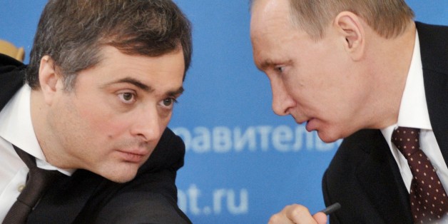 FILE - In this Feb. 13, 2012 file photo, , Russian Prime Minister Vladimir Putin, right, speaks to Vladislav Surkov, deputy prime minister in charge of economic modernization, during a visit in Kurgan, Russia. The United States and its European allies stepped up their pressure on Russia to end its intervention in Ukraine by imposing the most comprehensive sanctions against Russian officials since the Cold War. Surkov is on the list. (AP Photo/RIA Novosti, Alexei Nikolsky, Government Press Service, file)