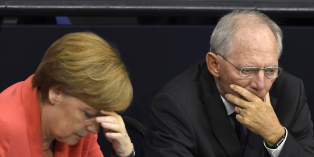 German Chancellor Angela Merkel (L) confer with finance minister Wolfgang Schaeuble during a debate in the Bundestag, the German lower house of parliament in Berlin on July 17, 2015. German lawmakers will vote during todays sitting in the Bundestag on entering into negotiations on the new aid package for Greece. AFP PHOTO / TOBIAS SCHWARZ (Photo credit should read TOBIAS SCHWARZ/AFP/Getty Images)