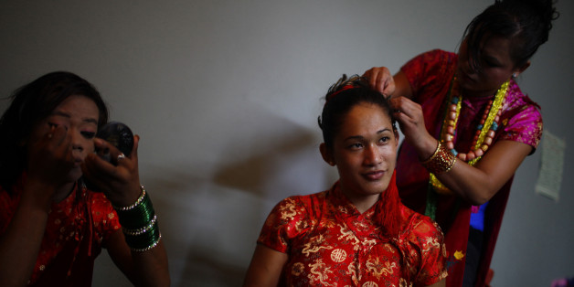 Participants prepare for a gay rally in Pokhara 200 kilometers (125 miles) from Katmandu, Nepal, Friday, Aug. 3, 2012. Hundreds of gay, lesbian, transgender people marched in a Nepal town to demand recognition as a third gender in citizen certificates, to allow same-sex marriage and support criminalizing discrimination based on sexual preference. (AP Photo/Niranjan Shrestha)