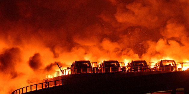 TIANJIN, CHINA - AUGUST 13: (CHINA OUT) Fire and smoke are seen after explosions at a warehouse on late Wednesday in Binhai New Area on August 13, 2015 in Tianjin, China. At least 17 people dead, 32 are in critical condition and at least another 400 injured during the explosions of a warehouse on late Wednesday in Binhai New Area in Tianjin, according to police authority. (Photo by Tong Yu/CNSPHOTO/ChinaFotoPress via Getty Images)