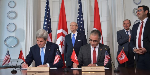 US Secretary of State John Kerry (L) and Tunisian Minister of Political Affairs Mohsen Marzouk (R) sign an memorandum of understanding watched by Tunisian President Beji Caid Essebsi (C) at Blair House, the presidential guest house, on May 20, 2015 in Washington, DC. AFP PHOTO/MANDEL NGAN (Photo credit should read MANDEL NGAN/AFP/Getty Images)