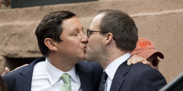 David Turley, center, and Peter Thiede, kiss before getting married, Sunday, June 28, 2015 in front of New York's Stonewall Inn. Friday the U.S. Supreme Court legalized gay marriage across the 50 states. (AP Photo/Mark Lennihan)