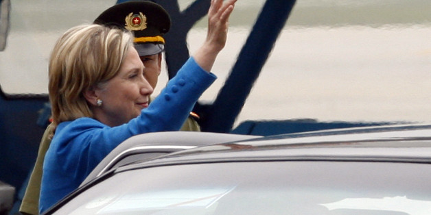 U.S. Secretary of State Hilary Clinton waves her hand to the media upon her arrival at the airport in Hanoi, Vietnam Thursday, July 22, 2010. (AP Photo/Kham, Pool)