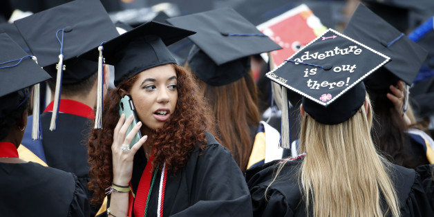 Graduates are seated during George Washington University's commencement exercises on the National Mall, Sunday, May 17, 2015 in Washington. Apple CEO Tim Cook gave the commencement address and was awarded an honorary degree of public service. (AP Photo/Alex Brandon)