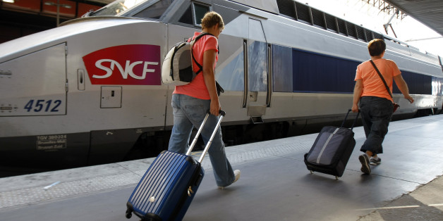 People walk on a platform to take a TGV (High Speed Train) at the Gare St-Charles station in Marseille, southern France , Thursday, June 12, 2014, as French rail workers strike to protest against plans to open the railways to competition. Workers on the French national railway SNCF are striking over plans to streamline and open the state-run network, considered among the world's best, to private competition. (AP Photo/Claude Paris)