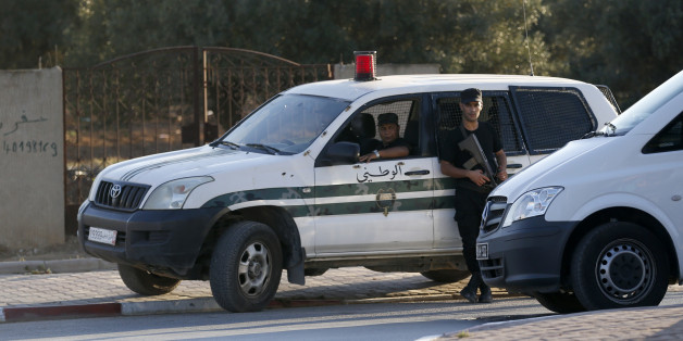 Tunisian police officers guard the street near the attacked Imperial Marhaba hotel in Sousse, Tunisia, Saturday, June 27, 2015. The morning after a lone gunman killed dozens of people at a beach resort in Tunisia, busloads of tourists are heading to the nearby Enfidha-Hammamet airport hoping to return to their home countries. (AP Photo/Darko Vojinovic)