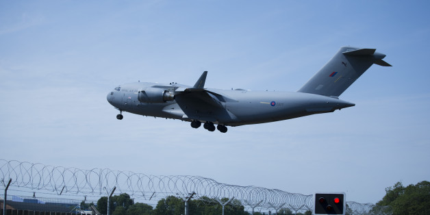 A plane repatriating some of the British victims of the Tunisia beach attack comes in to land at the RAF (Royal Air Force) Brize Norton base in Brize Norton, England, Wednesday, July 1, 2015. Britain on Wednesday began repatriating the remains of victims of last week's terror attack at a Tunisian beach resort. (AP Photo/Matt Dunham)