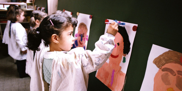 SMALL CHILDREN IN CLASSROOM PAINTING PORTRAITS