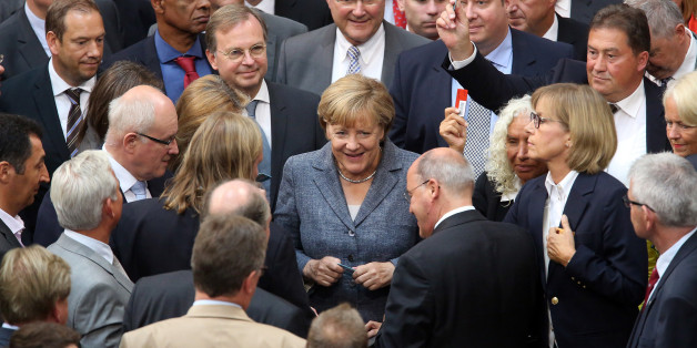 BERLIN, GERMANY - AUGUST 19: German Chancellor Angela Merkel (CDU) casts her vote on a third bailout package for economically-troubled Eurozone member Greece as she attends a meeting of the German federal parliament, or Bundestag, on August 19, 2015 in Berlin, Germany. European governments vote on the issue this week. Merkel and the country's finance minister, Wolfgang Schaeuble, have encouraged German parliamentarians to support the latest plan, evaluated at 86 billion euros (USD 95.5 billion). Meanwhile the leaders praised the Greek government for accepting German prerequisites for the offer, and have assured that the International Monetary Fund (IMF) would participate in the latest bailout package. (Photo by Adam Berry/Getty Images)