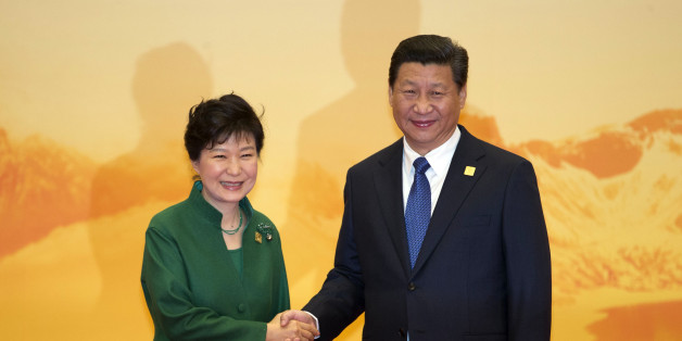 South Korean President Park Geun-hye shakes hands with Chinese President Xi Jinping during a welcome ceremony for the Asia-Pacific Economic Cooperation (APEC) Economic Leaders Meeting held at the International Convention Center in Yanqi Lake, Beijing, on Tuesday, Nov 11, 2014. (AP Photo/Ng Han Guan)