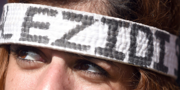 A demonstrator wears a headband reading Yazidis , in Hannover, Germany, Saturday Aug. 16, 2014. Thousands of people in Germany have protested against the persecution of the Yazidi minority in Iraq. Police say at least 10,000 people attended the biggest demonstration in the north German city of Hannover on Saturday. Protesters carried banners demanding that the international community protect the Yazidi people and other minorities from the Islamist State extremist group. (AP Photo/dpa,Swen Pfoertner)