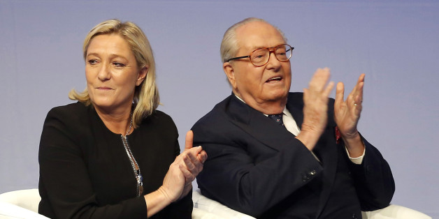 FILE - In this Saturday Nov. 29, 2014 file photo, French far-right Front National leader Marine Le Pen and her father Jean-Marie Le Pen applaud in Lyon, central France. A French court has reinstated Thursday July 2, 2015 Jean-Marie Le Pen as a member of the far right National Front party he founded decades ago, sending a biting blow to his daughter and party president Marine Le Pen, who had suspended him after a series of controversial and anti-Semitic statements. (AP Photo/Laurent Cipriani, Fil