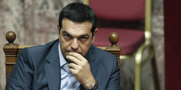 Greek Prime Minister Alexis Tsipras listens during a parliamentary session in Athens, Friday, Aug. 14, 2015. Greek lawmakers are continuing a debate in parliament to approve a massive new bailout deal after repeated delays over procedure and dissent within the governing left-wing Syriza party caused the session to last through the night. (AP Photo/Yannis Liakos)